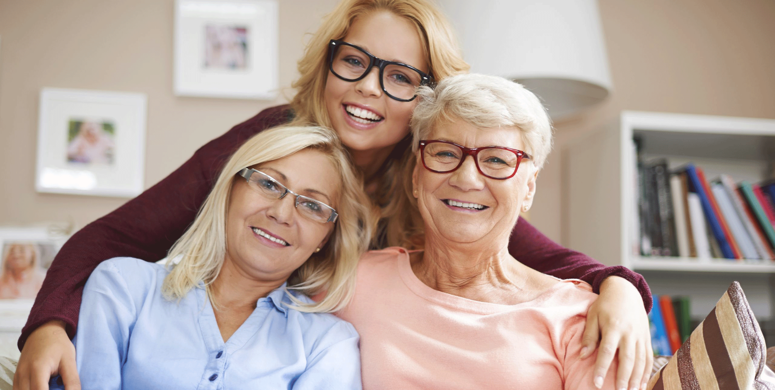 Three middle aged women hugging and looking at the camera